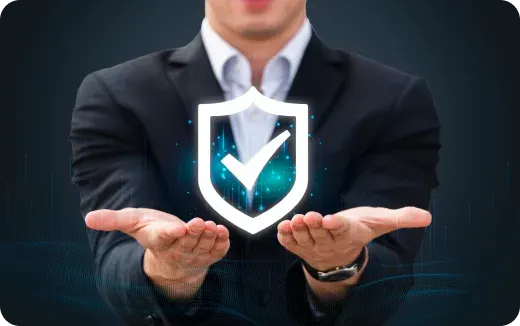 Person in business attire holding a glowing shield icon with a checkmark symbolizing protection and security.